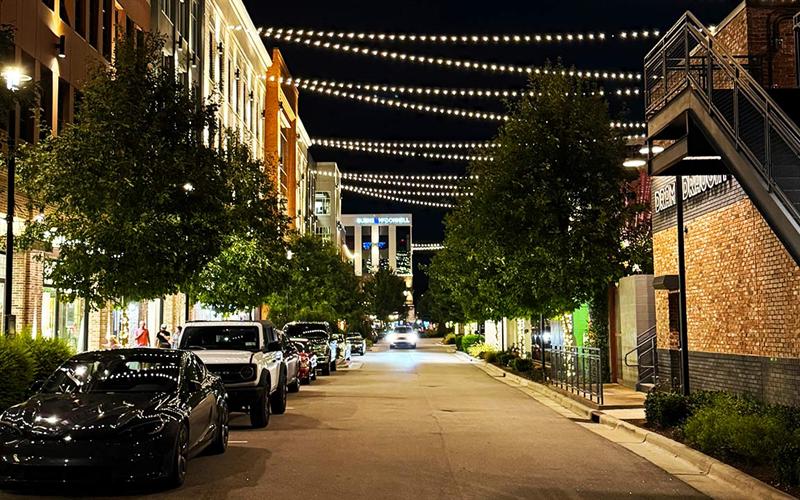 Shops and string lights at Fenton in Cary, NC at night